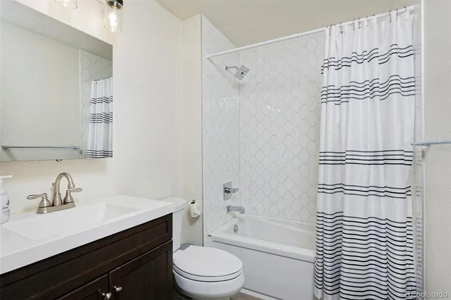 a bathroom with a sink a toilet a shower and a mirror