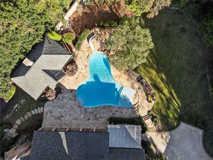 a living room with fireplace furniture and a floor to ceiling window