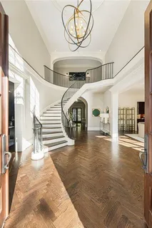 a living room with furniture a fireplace a flat screen tv and kitchen view