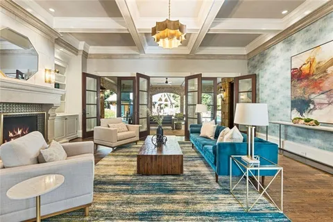 a bedroom with a large bed wooden floor and window