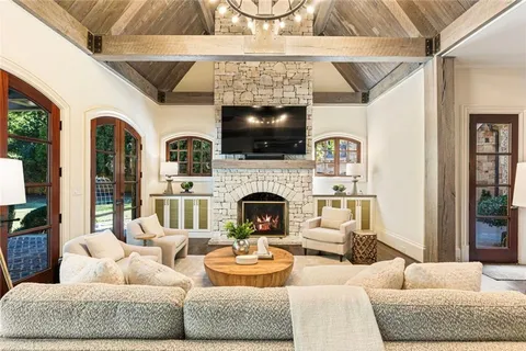 a view of a patio with table and chairs potted plants with wooden floor