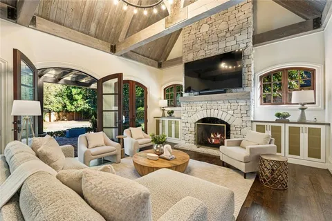 a view of a swimming pool with a patio and a yard