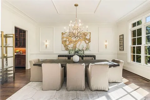 a living room with furniture a fireplace and a floor to ceiling window