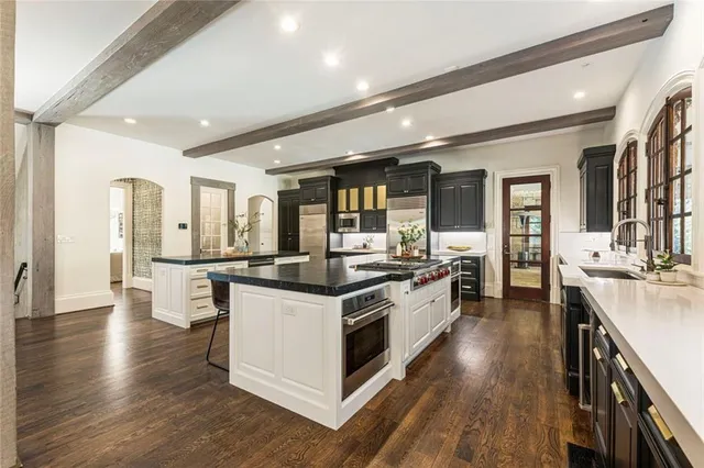 a bathroom with a toilet a sink a mirror a bathtub and shower