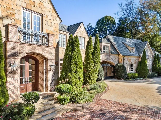 a view of hall way with furniture and chandelier