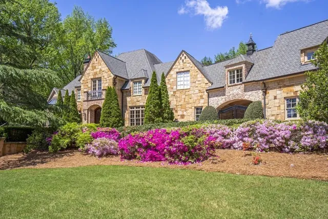 a living room with furniture a chandelier and a fireplace