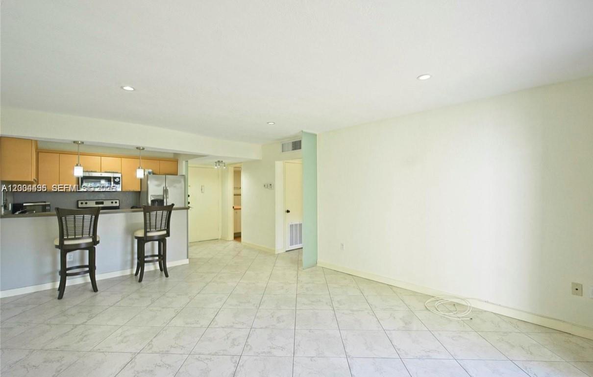 7401 Southwest 82nd Street, Unit 207S Miami, FL 33143 - Photo 4 of 15 a view of cabinets and wooden floor