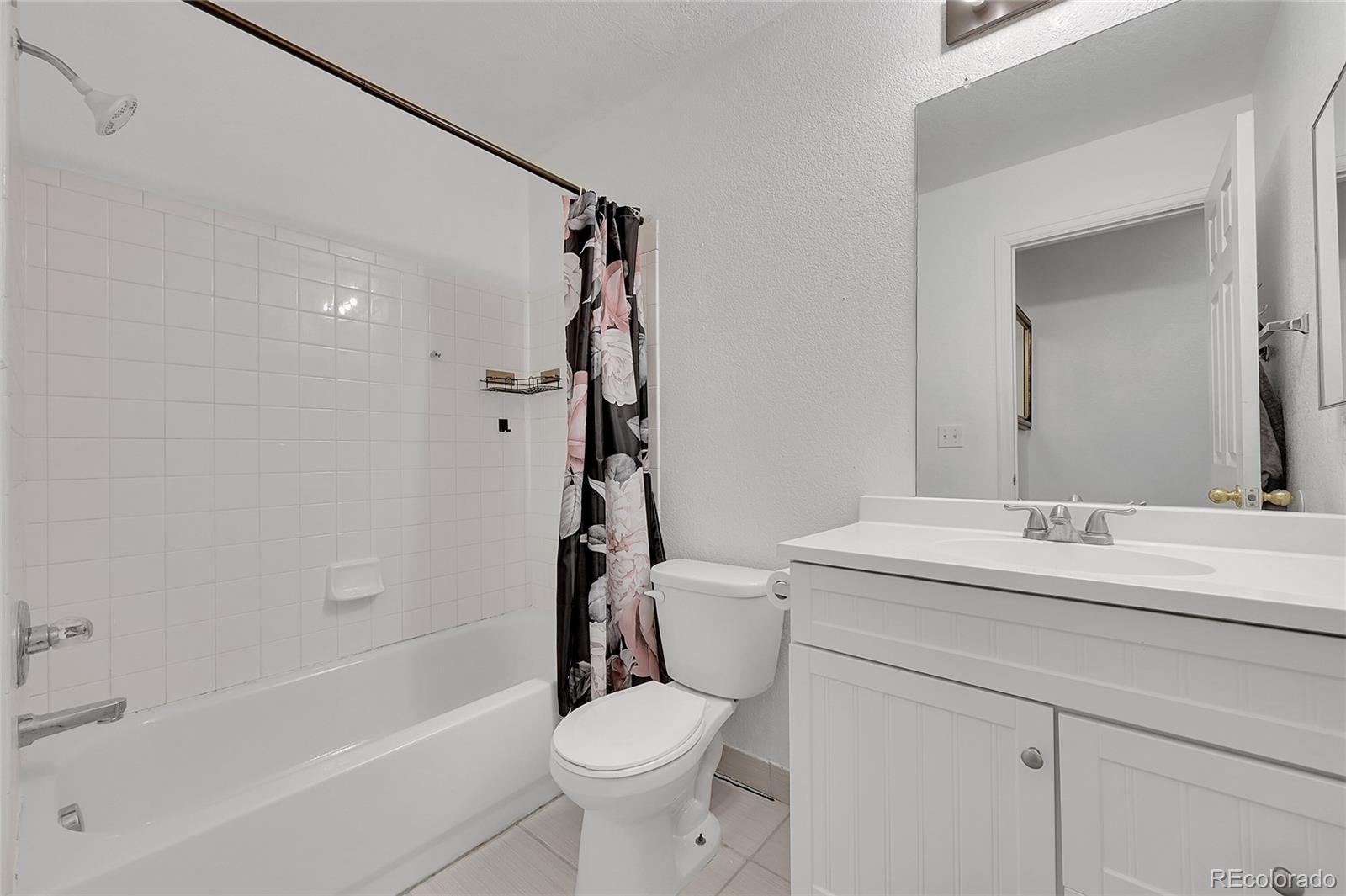 1489 Hummingbird Circle Brighton, CO 80601 - Photo 21 of 46 a bathroom with a sink toilet and shower