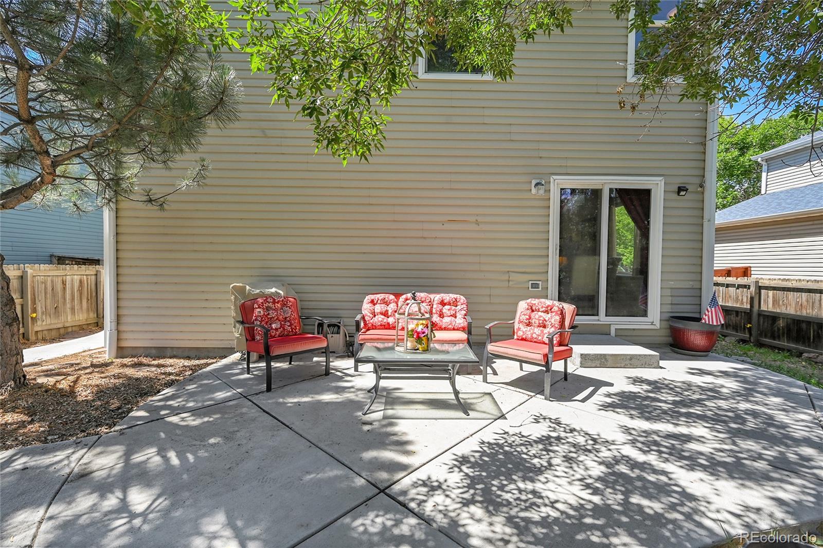 1489 Hummingbird Circle Brighton, CO 80601 - Photo 24 of 46 a bench is sitting in front of a house