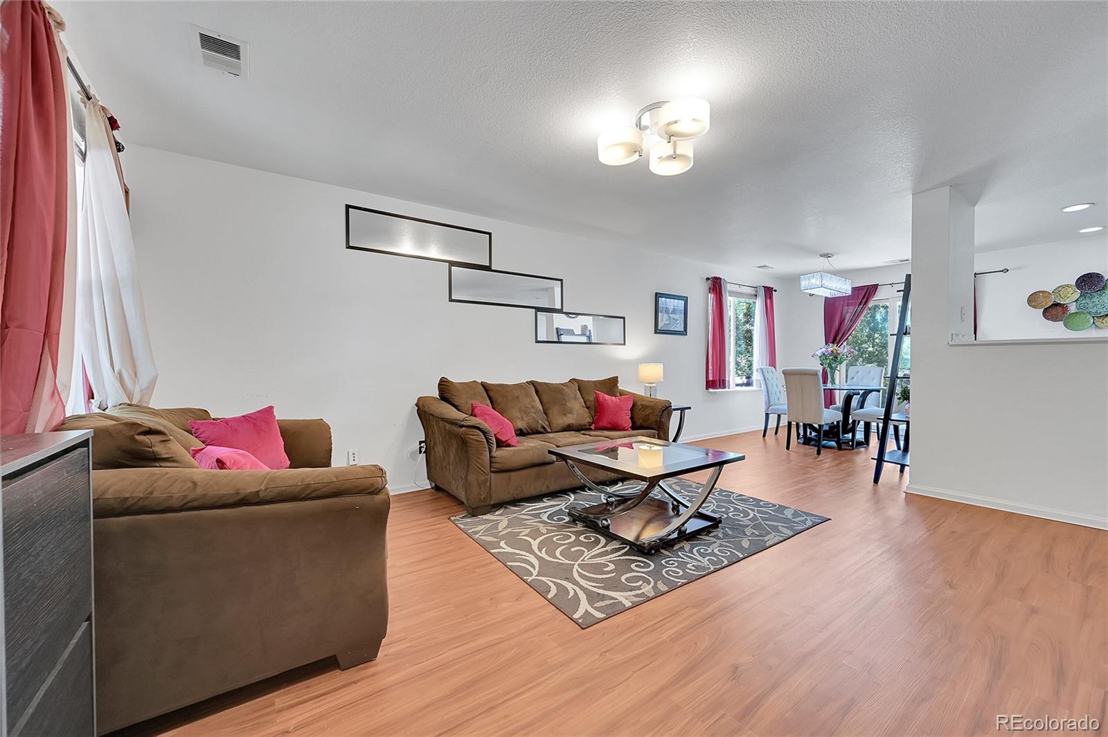 1489 Hummingbird Circle Brighton, CO 80601 - Photo 4 of 46 a living room with furniture and a wooden floor