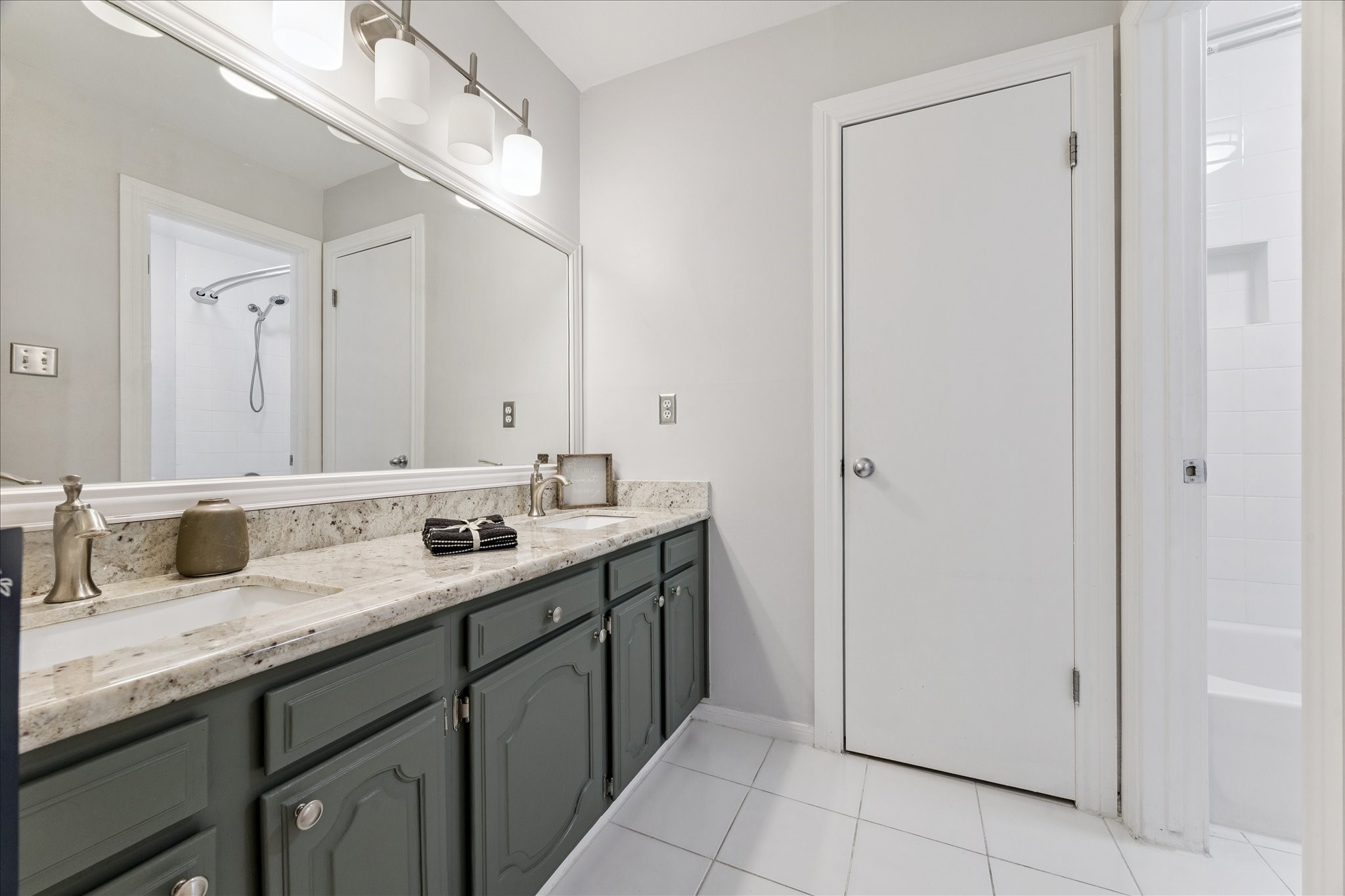 1201 Bering Drive, Unit 100 Houston, TX 77057 - Photo 13 of 20 a bathroom with a double vanity sink and a mirror