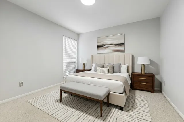 a bedroom with a bed and a night stand