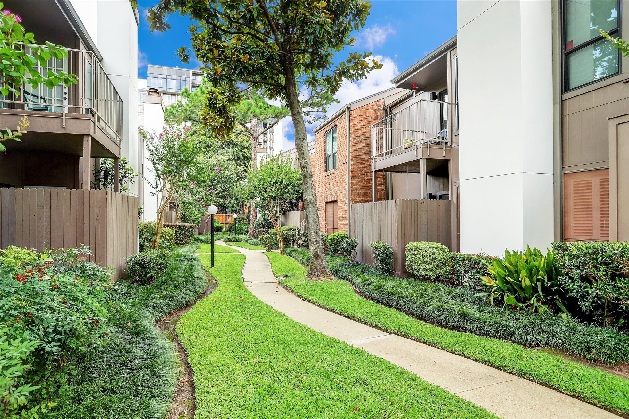 1201 Bering Drive, Unit 100 Houston, TX 77057 - Photo 2 of 20 a view of a house with a yard and plants