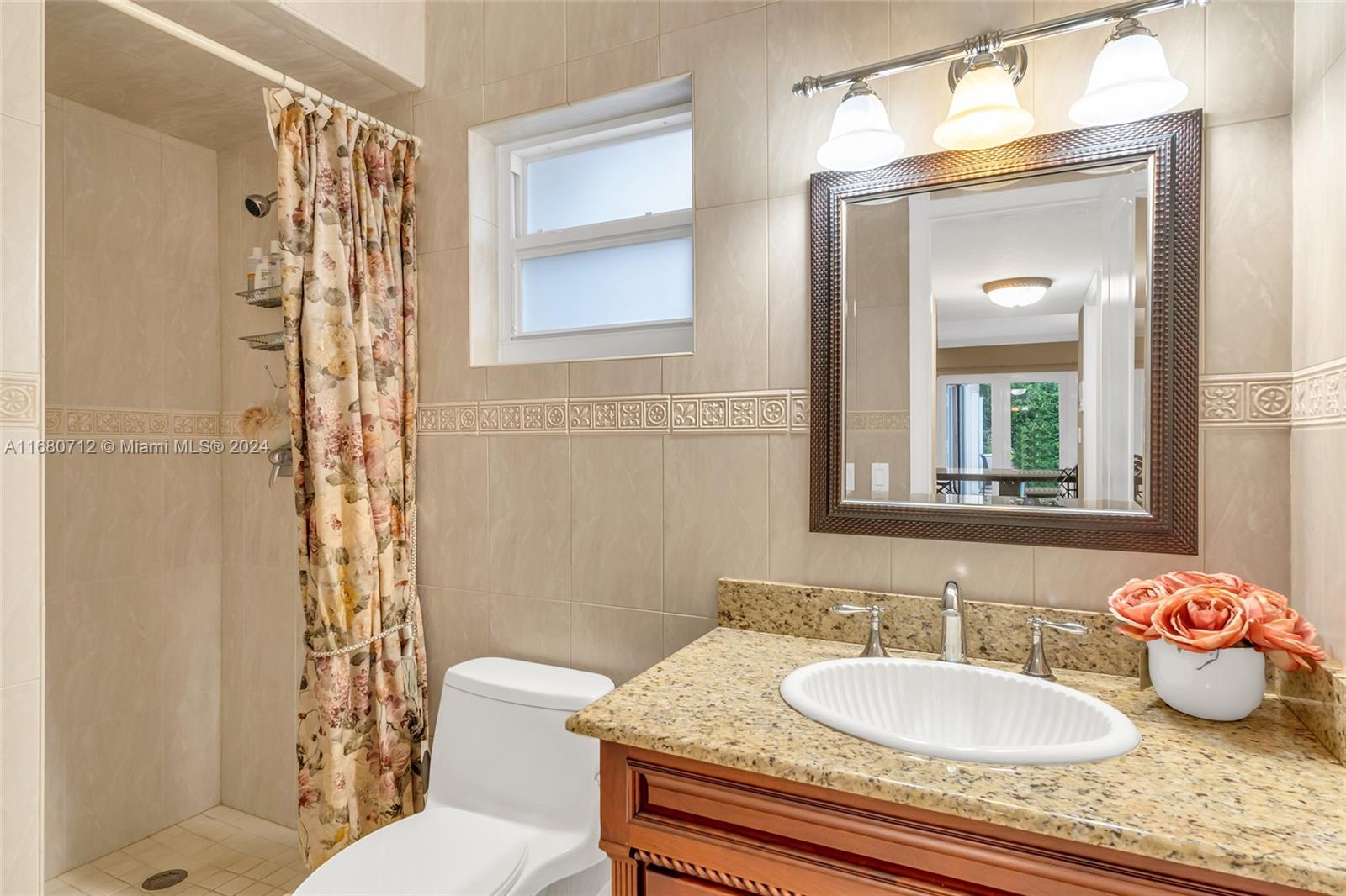 11451 Southwest 103rd Street Miami, FL 33176 - Photo 12 of 23 a bathroom with a granite countertop sink and a mirror