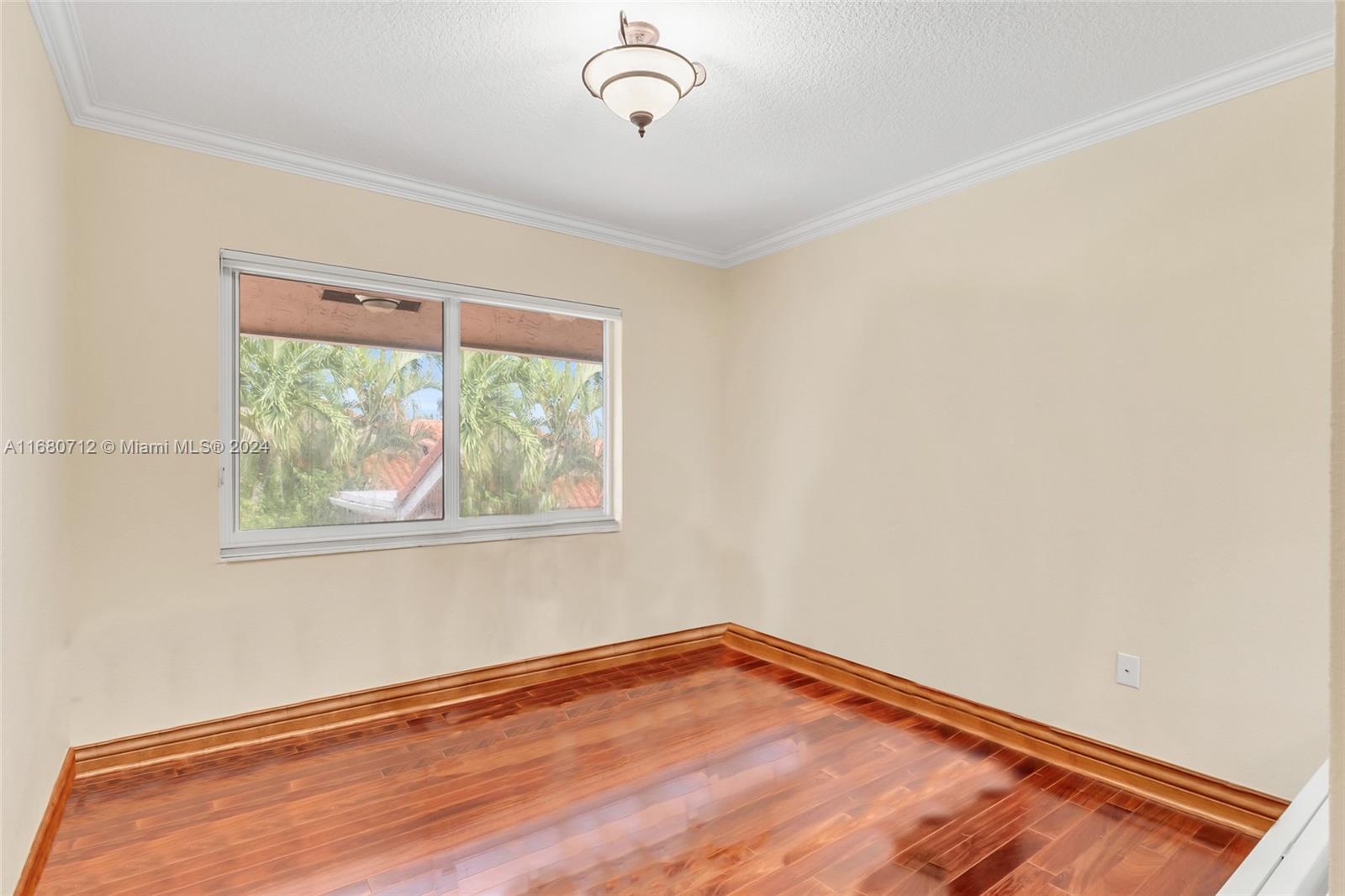 11451 Southwest 103rd Street Miami, FL 33176 - Photo 15 of 23 a view of empty room with wooden floor and fan