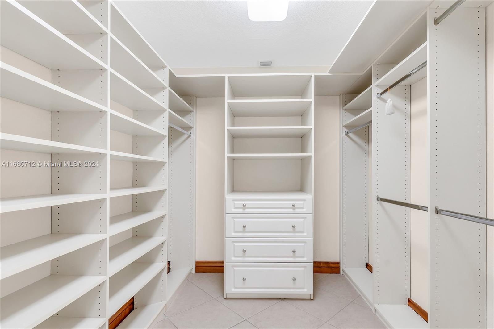 11451 Southwest 103rd Street Miami, FL 33176 - Photo 21 of 23 a view of walk in closet with empty racks