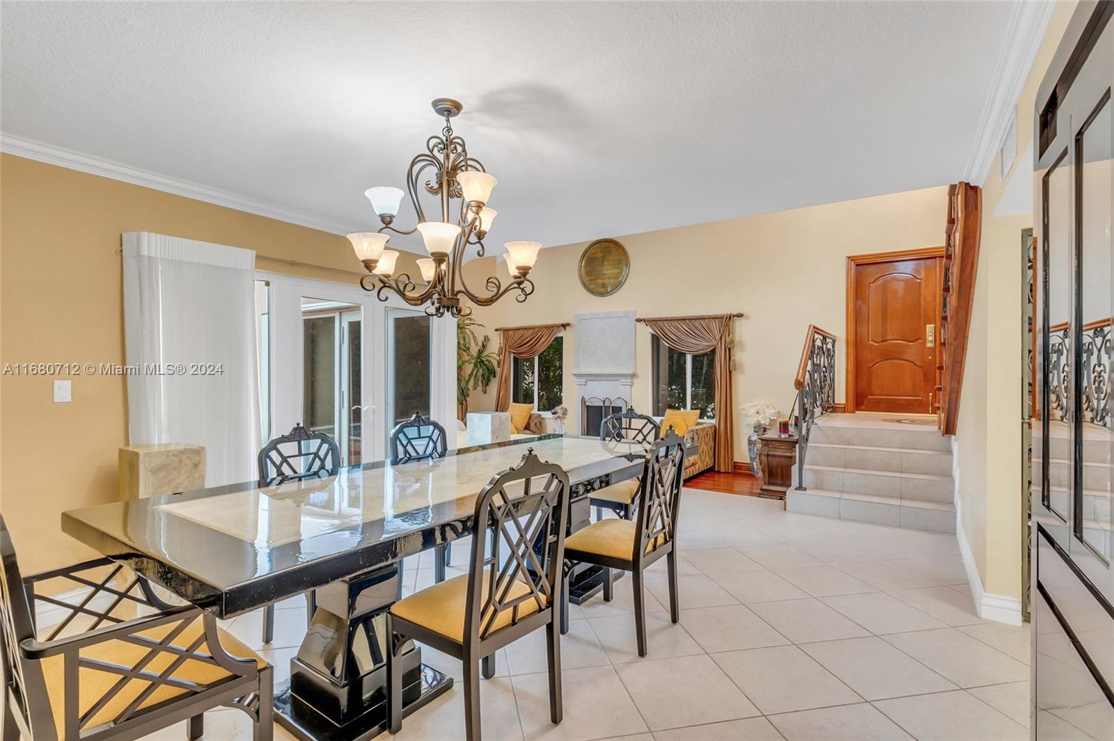 11451 Southwest 103rd Street Miami, FL 33176 - Photo 4 of 23 a view of a dining room with furniture and a chandelier