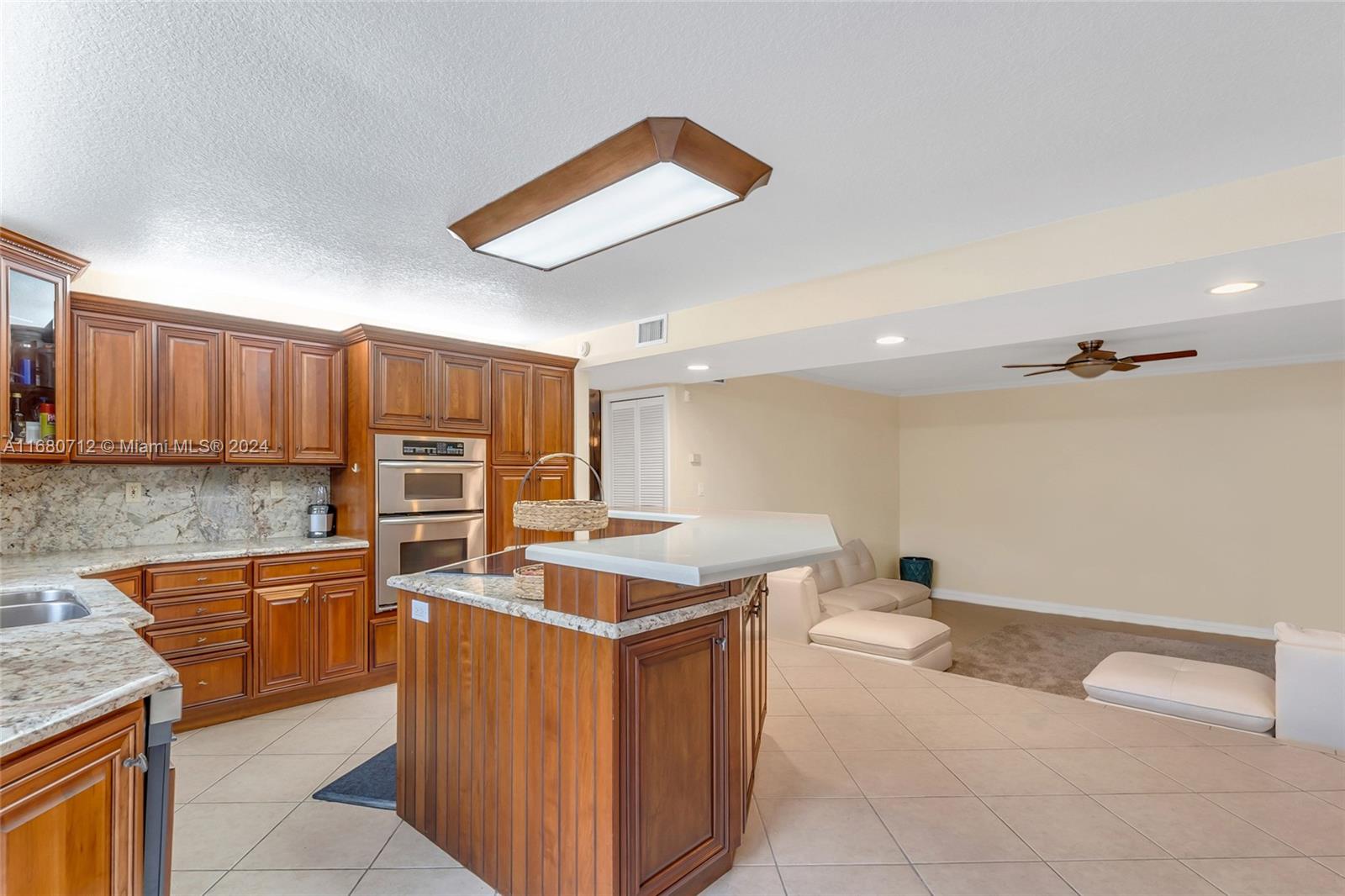11451 Southwest 103rd Street Miami, FL 33176 - Photo 7 of 23 a kitchen with stainless steel appliances granite countertop a sink counter space and cabinets