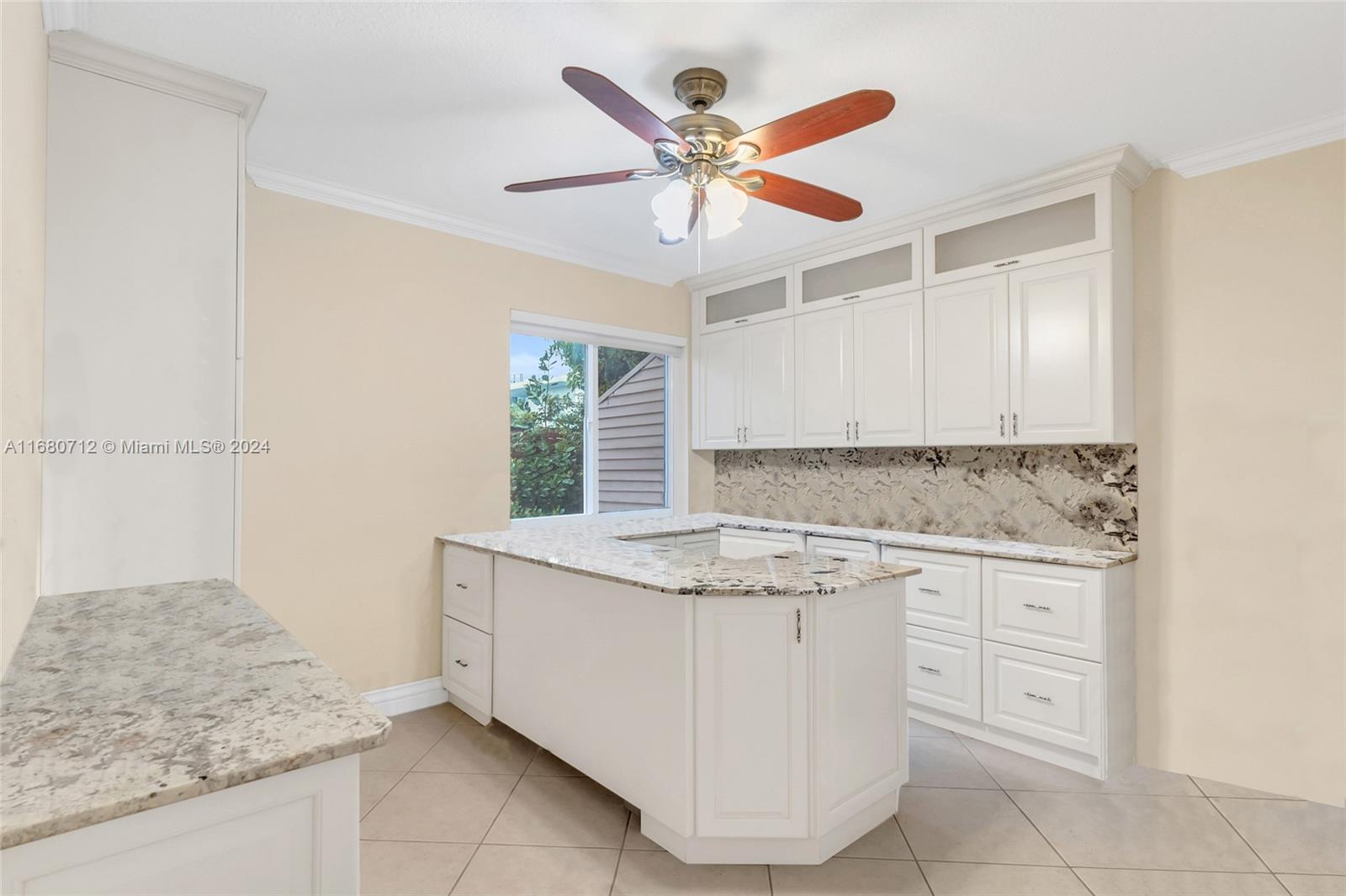 11451 Southwest 103rd Street Miami, FL 33176 - Photo 9 of 23 a kitchen with a stove cabinets and window