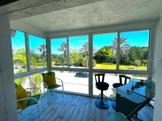 708 South Tamiami Trail, Unit 318 Venice, FL 34285 - Photo 11 of 13 a living room with furniture and a floor to ceiling window