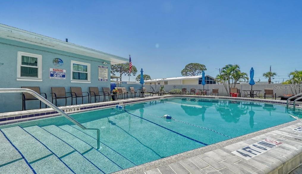 708 South Tamiami Trail, Unit 318 Venice, FL 34285 - Photo 13 of 13 a view of a swimming pool with a lounge chair