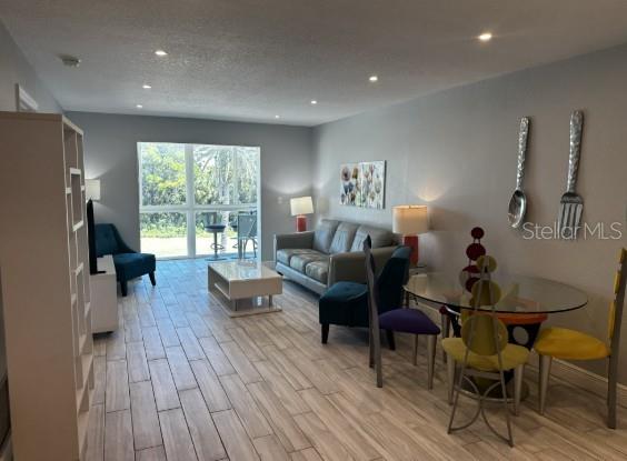 708 South Tamiami Trail, Unit 318 Venice, FL 34285 - Photo 2 of 13 a living room with furniture and a large window