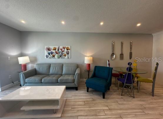 708 South Tamiami Trail, Unit 318 Venice, FL 34285 - Photo 3 of 13 a living room with furniture and a wooden floor