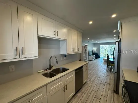 a kitchen with kitchen island a sink stove and cabinets