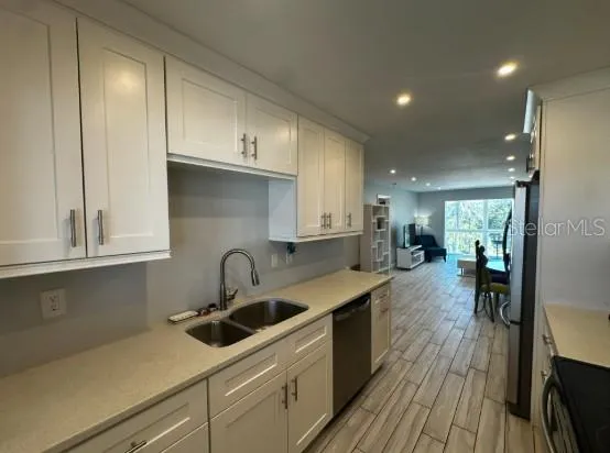 a kitchen with sink cabinets and window