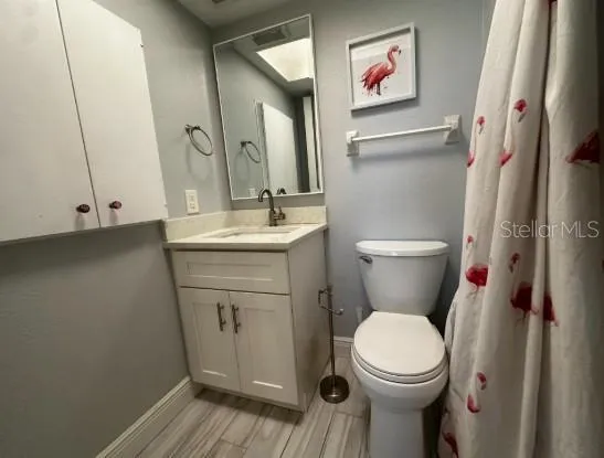 a white toilet sitting next to a bathroom sink