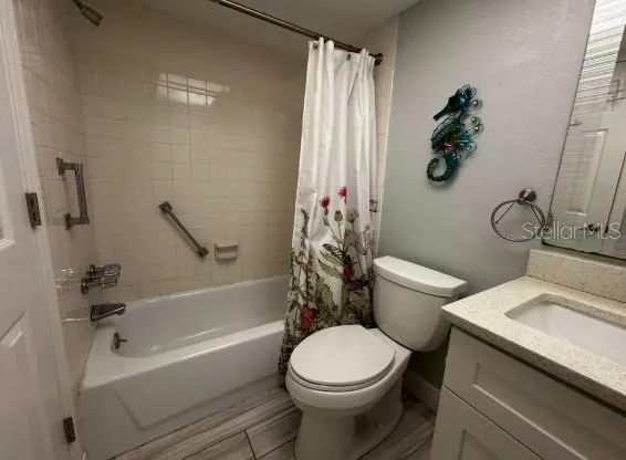 a white toilet sitting next to a bath tub