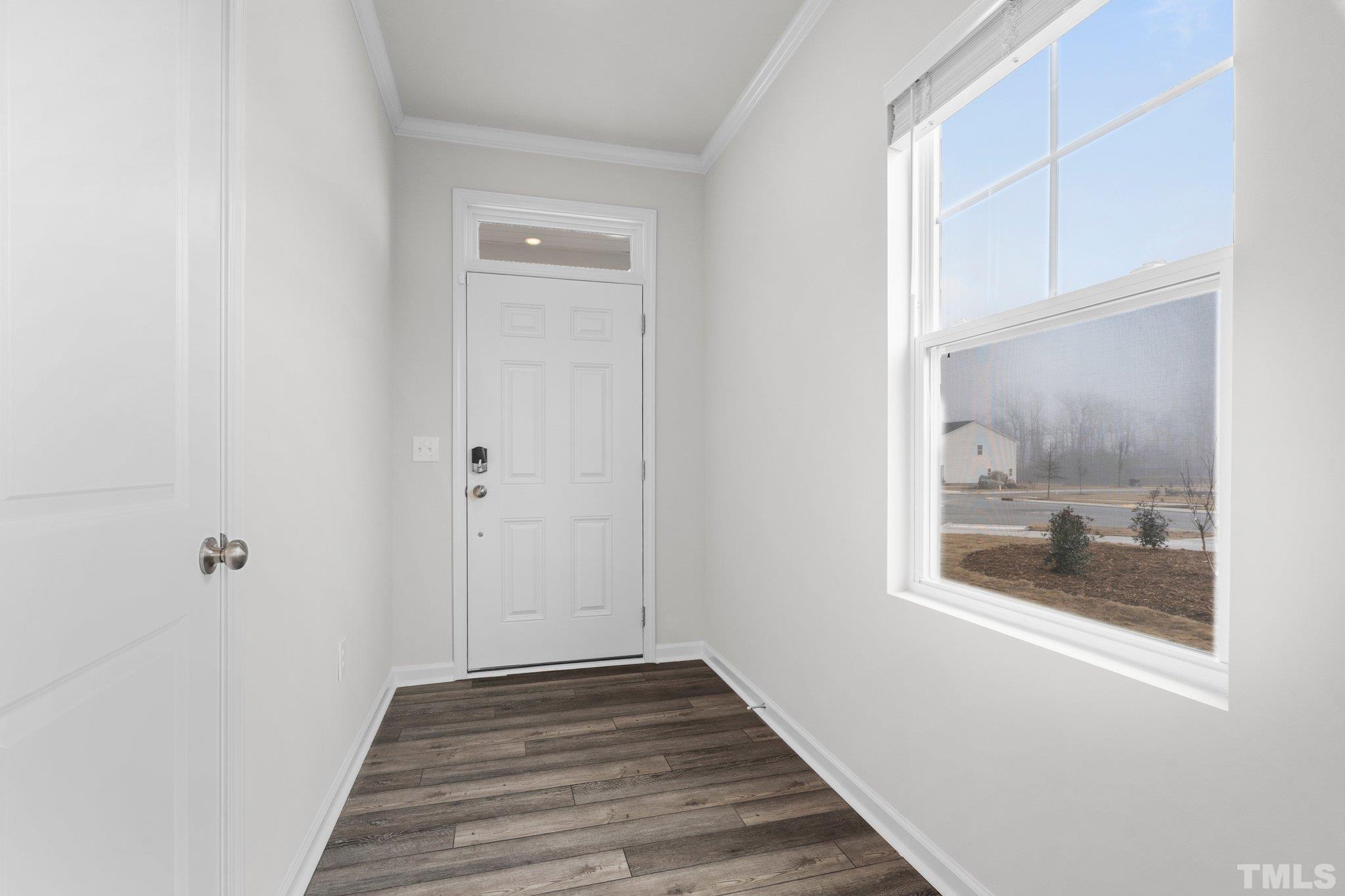 5060 Tura Street Raleigh, NC 27610 - Photo 14 of 50 a view of a hallway with wooden floor and a bathroom