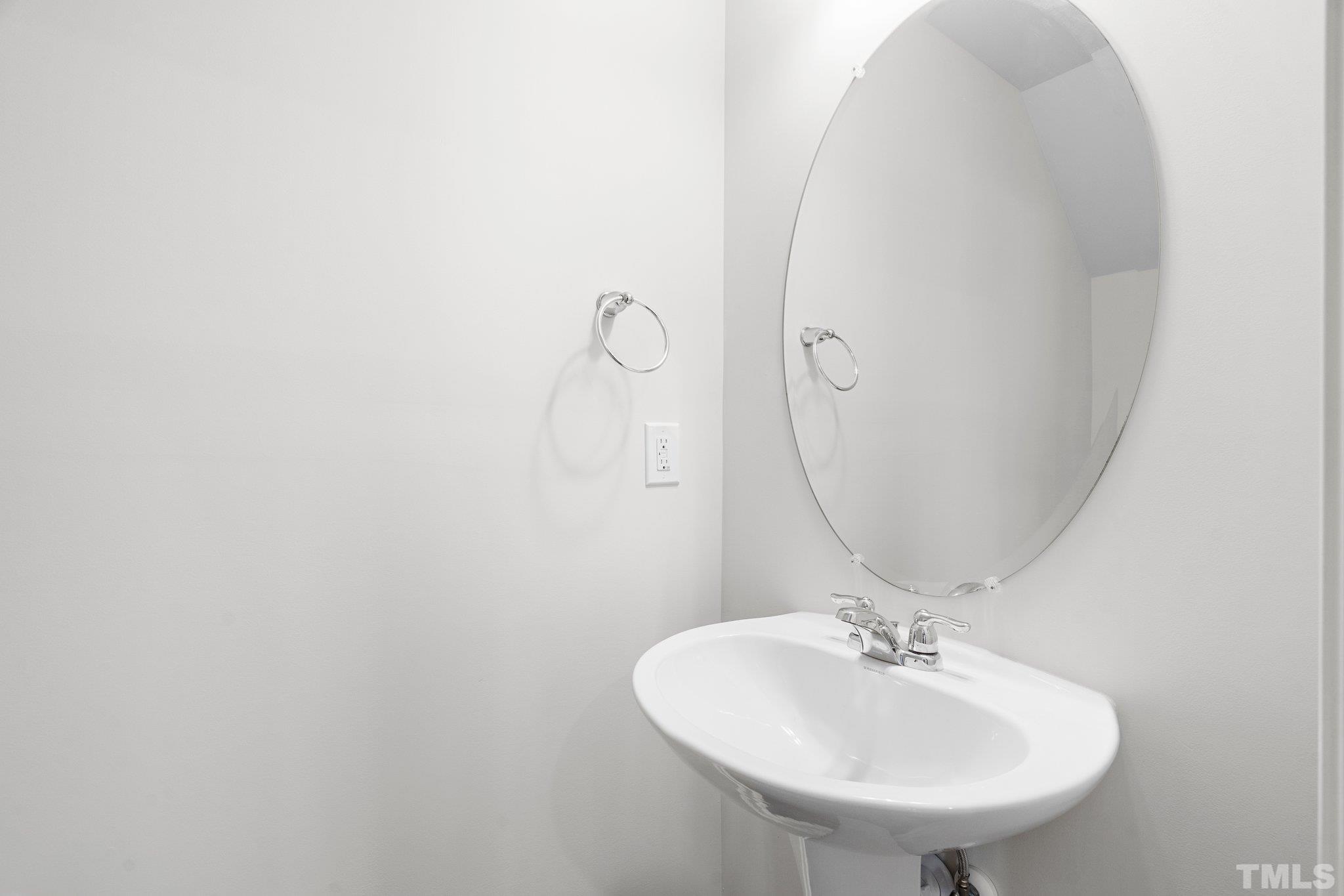 5060 Tura Street Raleigh, NC 27610 - Photo 22 of 50 a bathroom with a sink and mirror