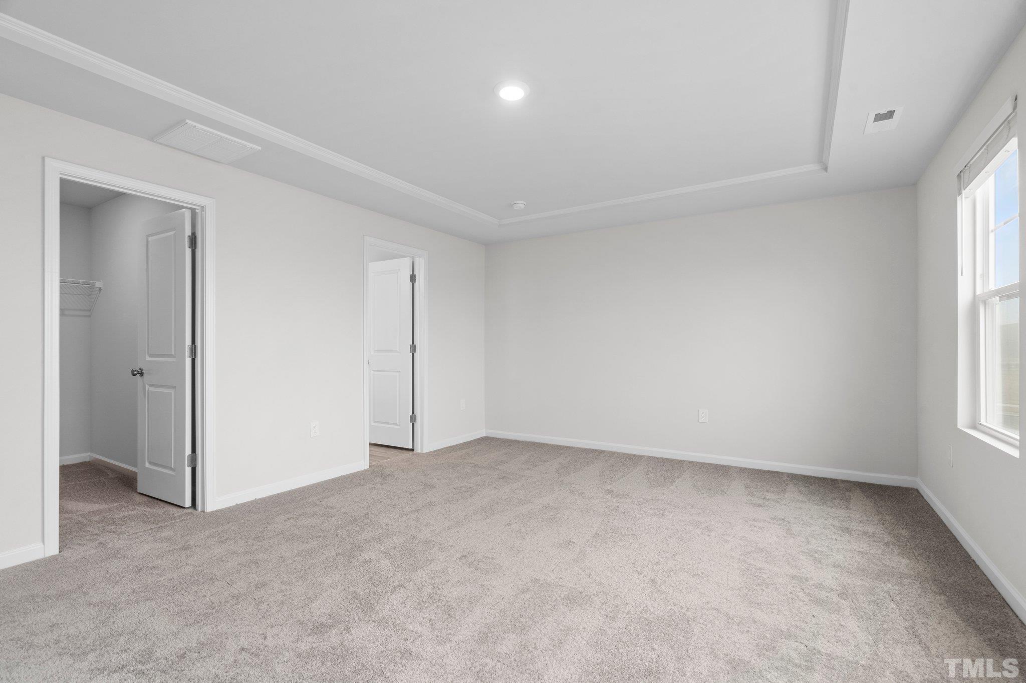 5060 Tura Street Raleigh, NC 27610 - Photo 25 of 50 an empty room with windows and entrance to other room