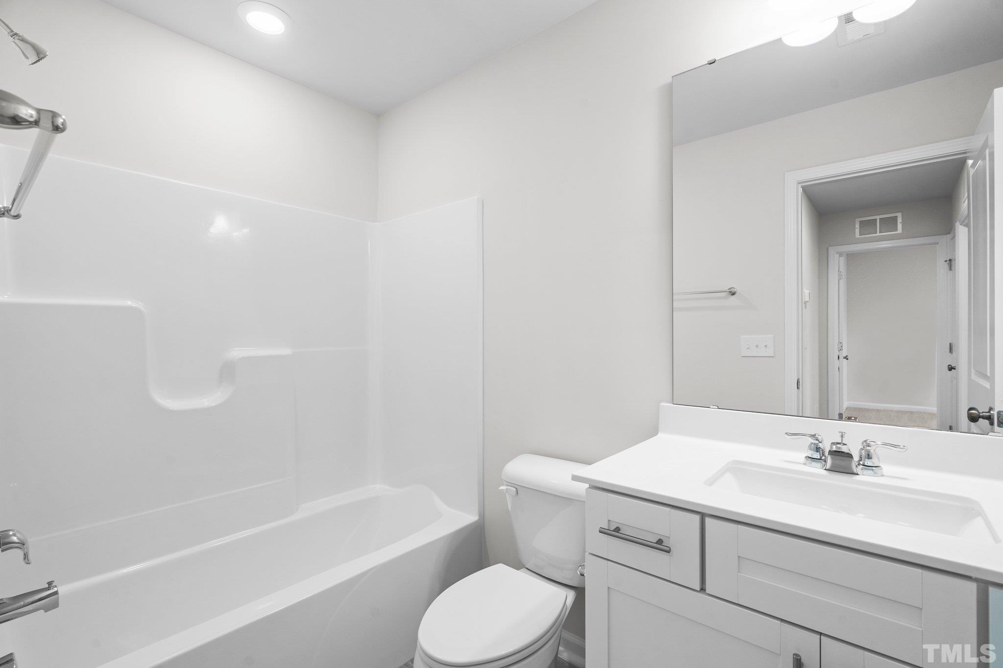 5060 Tura Street Raleigh, NC 27610 - Photo 30 of 50 a bathroom with a sink toilet and bathtub