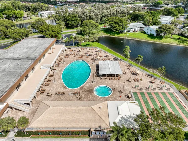 an aerial view of a house with a swimming pool and outdoor space