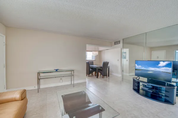 a living room with furniture and a piano