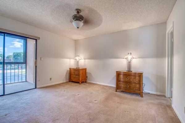 a view of a room with furniture and a ceiling fan