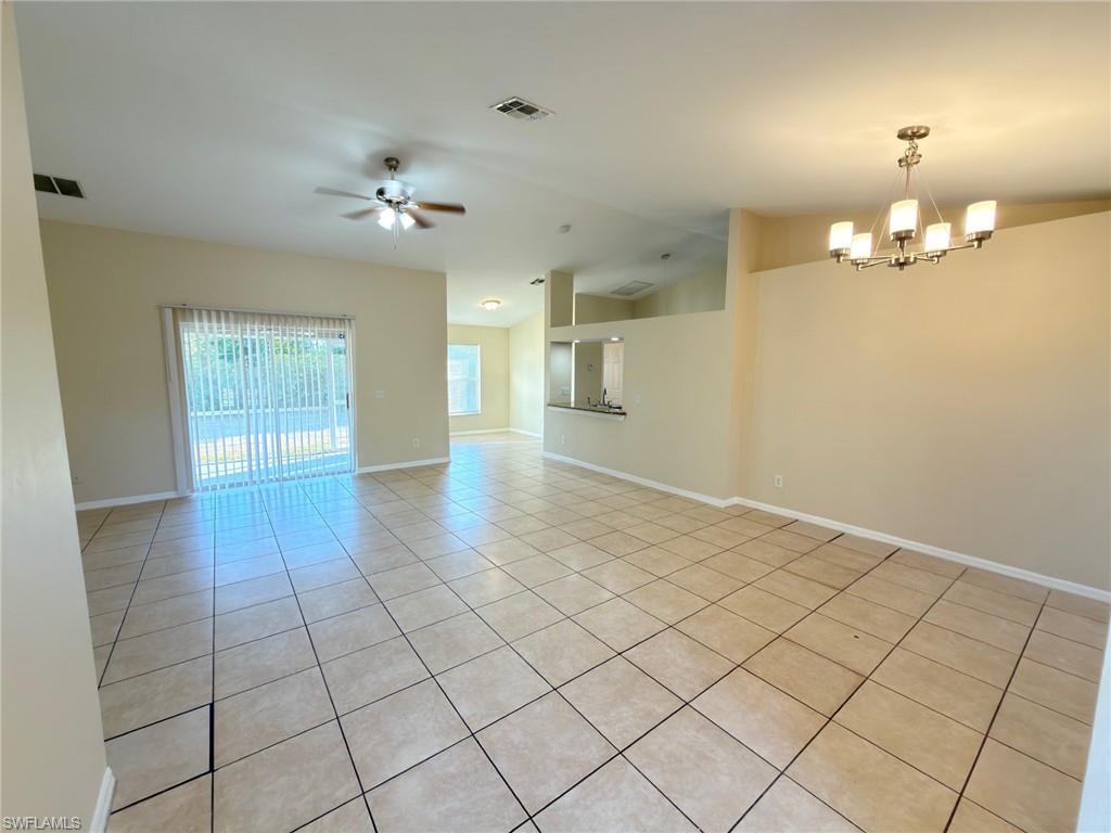 2513 48th Street Southwest Lehigh Acres, FL 33976 - Photo 13 of 22 wooden floor in an empty room with a window