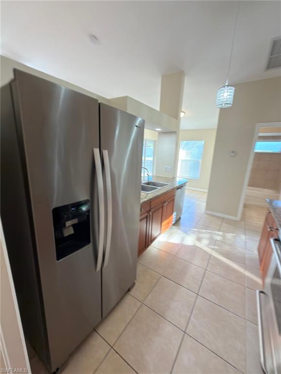 2513 48th Street Southwest Lehigh Acres, FL 33976 - Photo 18 of 22 a view of a refrigerator in kitchen and an empty room
