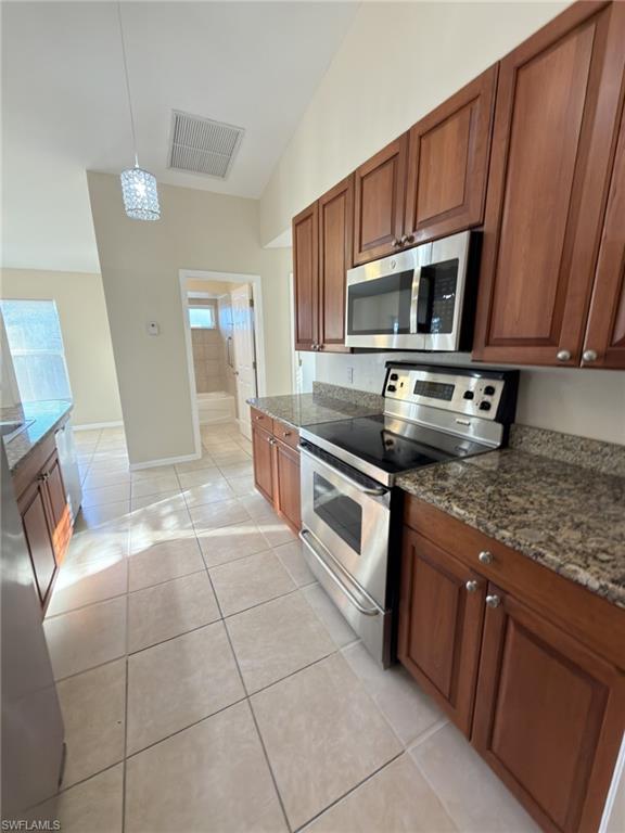 2513 48th Street Southwest Lehigh Acres, FL 33976 - Photo 21 of 22 a kitchen with stainless steel appliances granite countertop a sink stove and cabinets