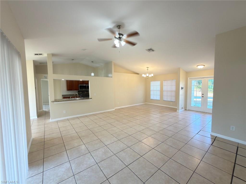 2513 48th Street Southwest Lehigh Acres, FL 33976 - Photo 9 of 22 a view of an empty room and a kitchen