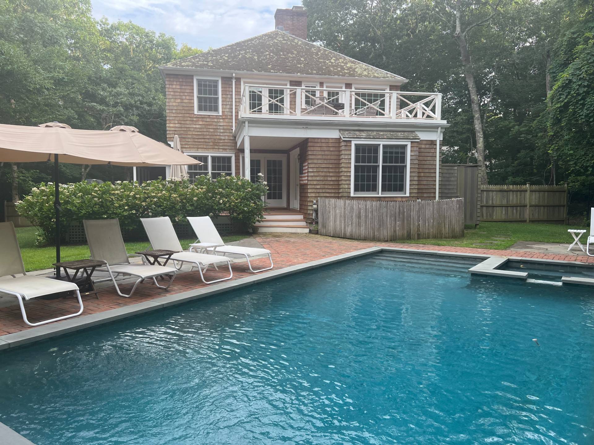 a view of a house with swimming pool and porch