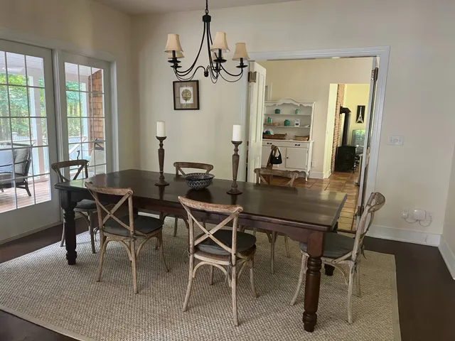 a view of a dining room with furniture and chandelier
