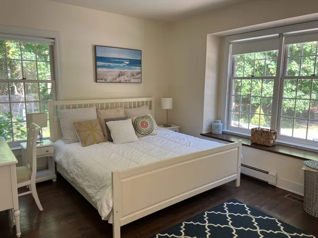 a bed sitting in a bedroom next to a window