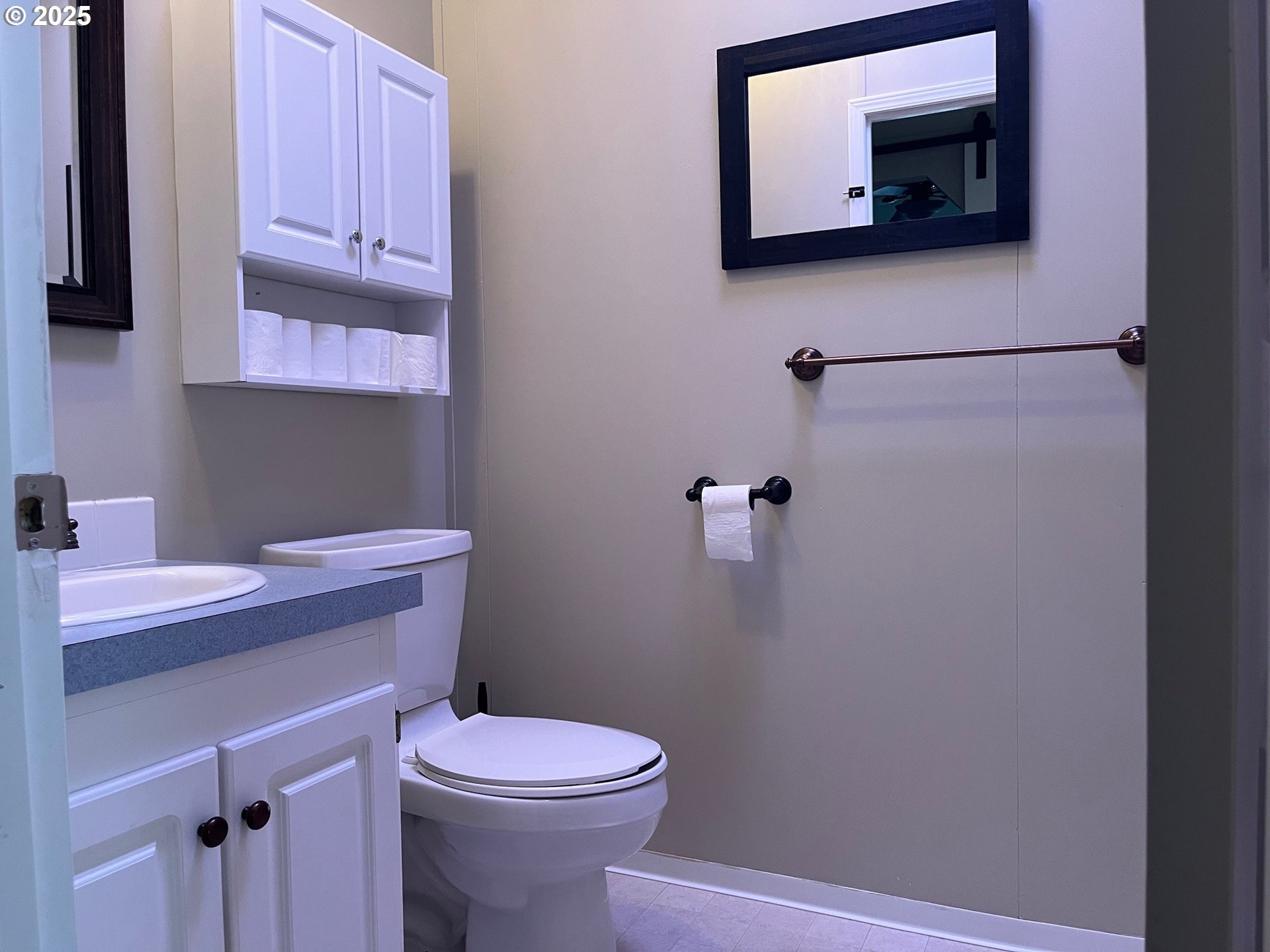 141 West River Ridge Avenue Roseburg, OR 97471 - Photo 7 of 20 a bathroom with a sink a toilet and mirror