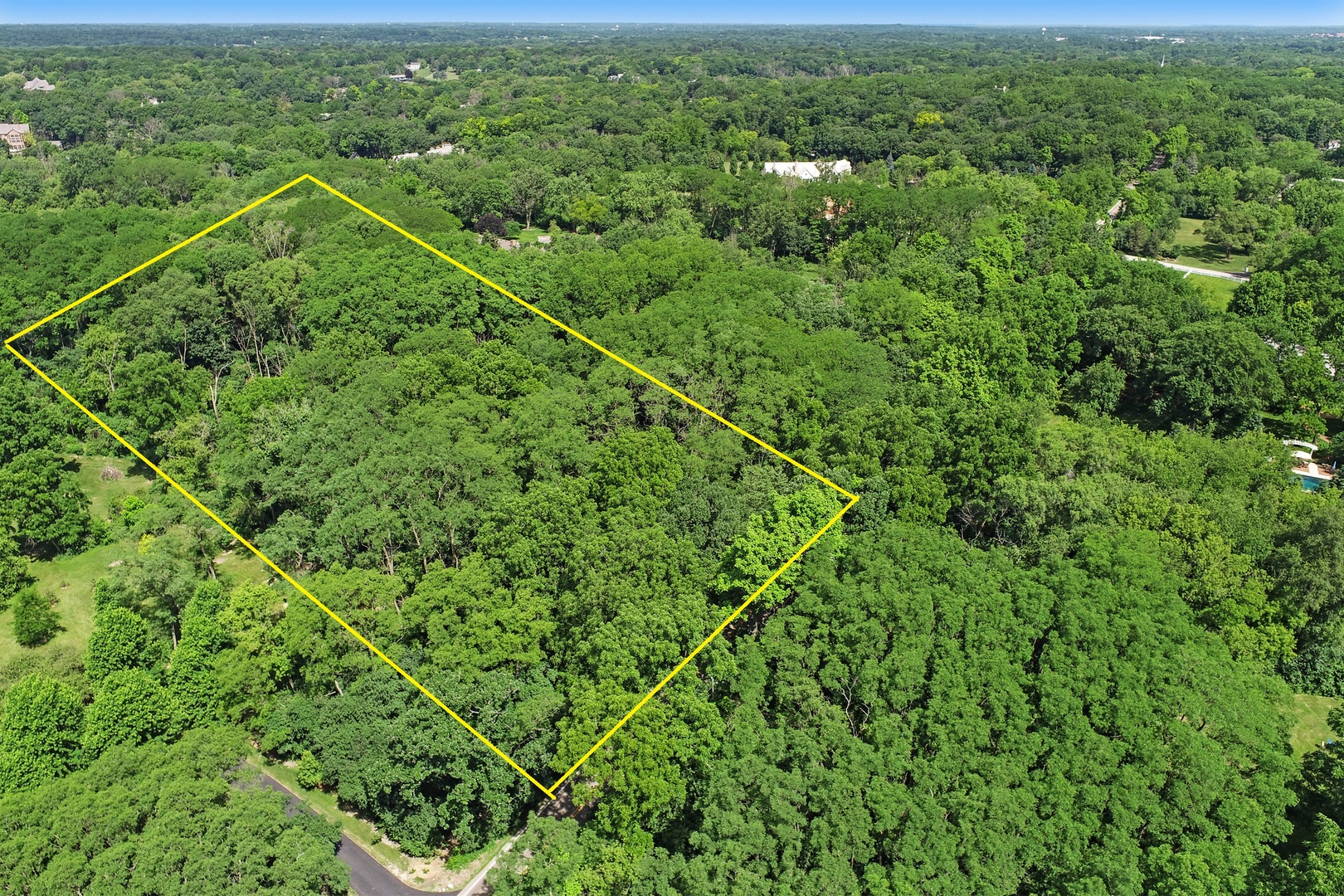 54 Brinker Road Barrington, IL 60010 - Photo 1 of 7 an aerial view of a house with a lush green forest