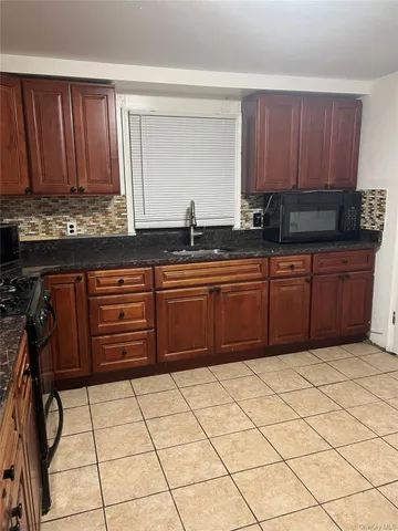 a kitchen with stainless steel appliances a sink and cabinets
