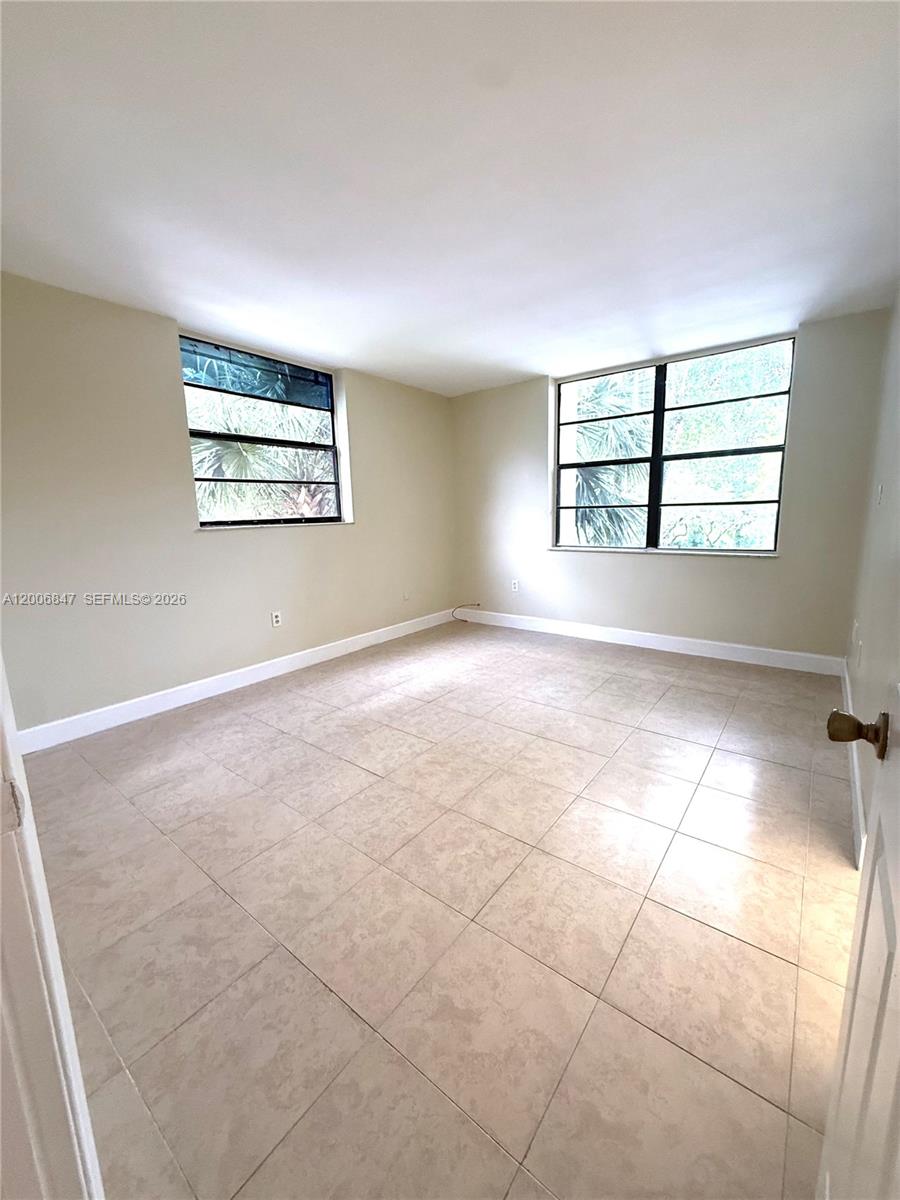10835 Southwest 112th Avenue, Unit 306 Miami, FL 33176 - Photo 13 of 19 an empty room with windows and painted walls