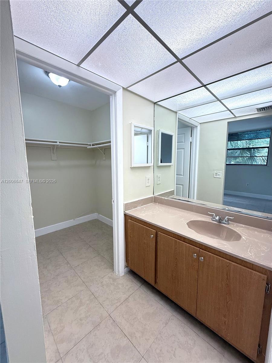 10835 Southwest 112th Avenue, Unit 306 Miami, FL 33176 - Photo 14 of 19 a bathroom with a double vanity sink and mirror